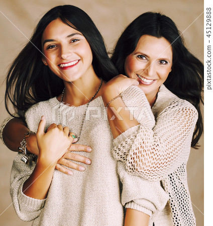 cute pretty teen daughter with mature mother hugging, fashion st cute pretty teen daughter with mature mother hugging, fashion st 45129888