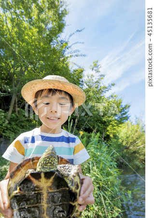 Boy caught a turtle in the river Boy caught a turtle in the river 45135681