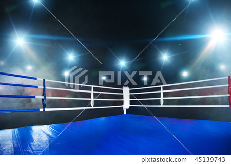 Empty boxing ring, view on corner with white ropes Empty boxing ring, view on corner with white ropes 45139743