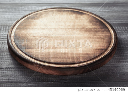 pizza cutting board at rustic wooden table Stock Photo by seregam