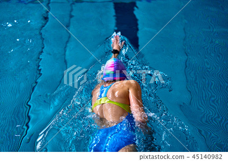 Female athlete swimming fast in crawl style.  45140982