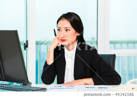 Beautiful businesswoman looking at computer 45142188