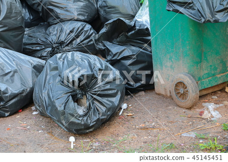 Pile black garbage bag roadside in the city  45145451