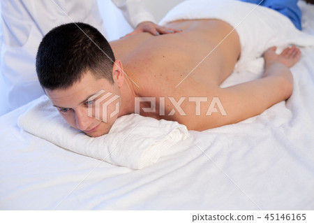 man doing medical massage and body treatments at the Spa 45146165