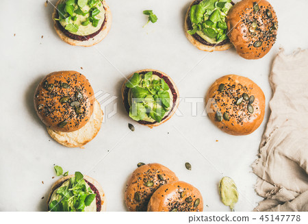 Healthy burgers with beetroot patties, avocado cream and green sprouts Healthy burgers with beetroot patties, avocado cream and green sprouts 45147778