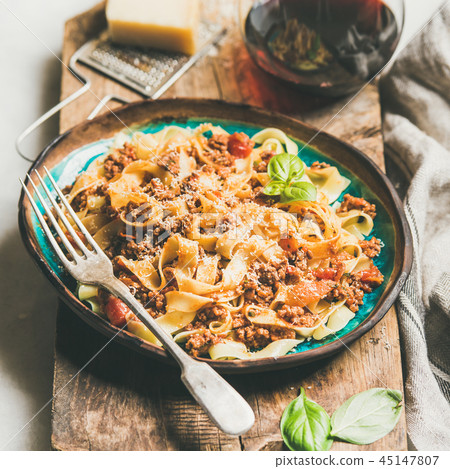Pasta dinner with tagliatelle bolognese and red wine, square crop 45147807