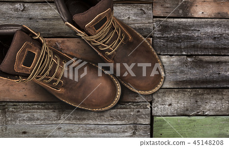 Brown men's boots, on a wooden background 45148208