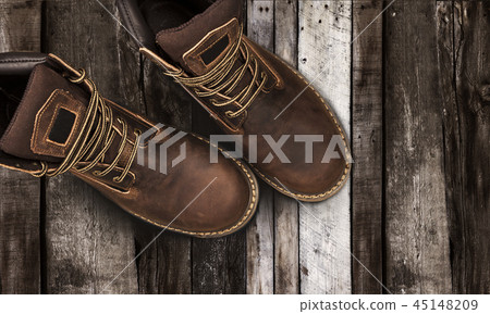 Brown men's boots, on a wooden background Brown men's boots, on a wooden background 45148209