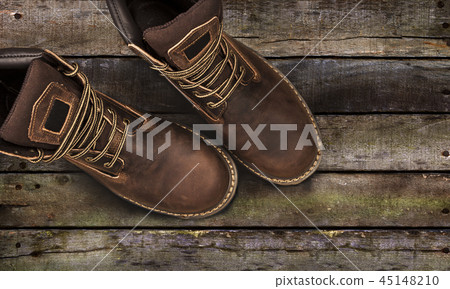 Brown men's boots, on a wooden background 45148210