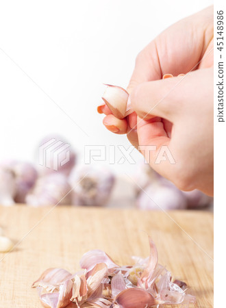 woman cook cleans garlic cloves 45148986