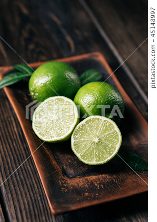 citrus, fresh limes, tropical fruits background 45148997