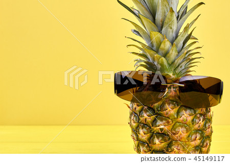 Ananas in male sunglasses and copy space. Ananas in male sunglasses and copy space. 45149117