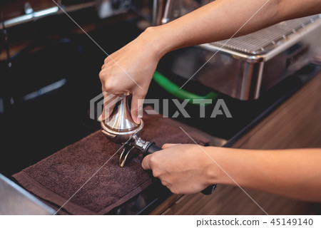 Barista preparing coffee beans grinded 45149140