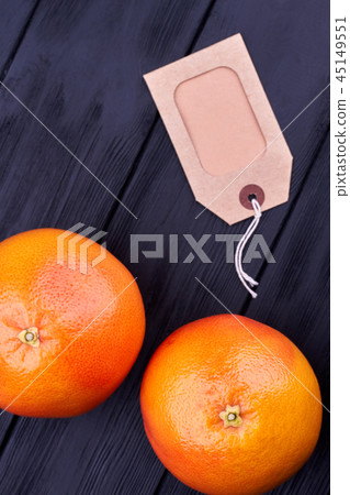 Ripe grapefruits and blank cardboard price tag. Ripe grapefruits and blank cardboard price tag. 45149551