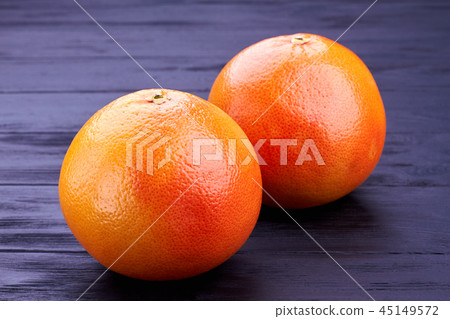 Close up two whole grapefruits. 45149572