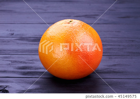 Whole fresh grapefruit on dark wood. Whole fresh grapefruit on dark wood. 45149575