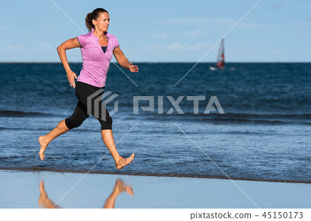 Active sporty woman run running on the beach Active sporty woman run running on the beach 45150173