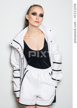 Fashion model in unzipped white sports suit. Fashion model in unzipped white sports suit. 45151056