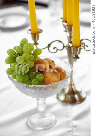 Vase with apricots and grapes on a high stem.Juicy fruit 45151925
