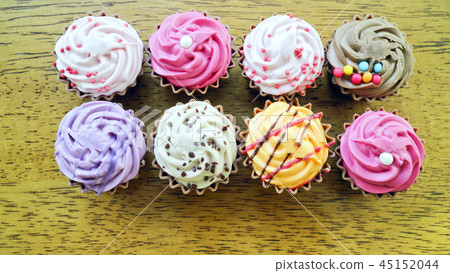 Top view of rows of colorful delicious cupcakes 45152044