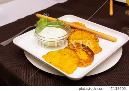 Draniki - potatoes and pumpkins, selective focus. 45158603