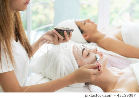 Beautiful woman having a facial treatment at spa. Beautiful woman having a facial treatment at spa. 45159097