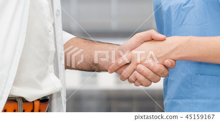 Doctor in hospital handshake with another doctor. 45159167