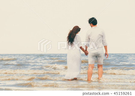 Couple going honeymoon on tropical beach in summer Couple going honeymoon on tropical beach in summer 45159261