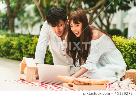 Young couple go picnic at the park in summer. 45159272