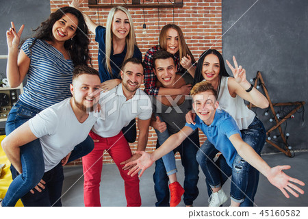 Group portrait of multi-ethnic boys and girls with colorful fashionable clothes holding friend Group portrait of multi-ethnic boys and girls with colorful fashionable clothes holding friend 45160582
