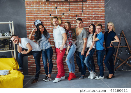 Group portrait of multi-ethnic boys and girls with colorful fashionable clothes holding friend Group portrait of multi-ethnic boys and girls with colorful fashionable clothes holding friend 45160611