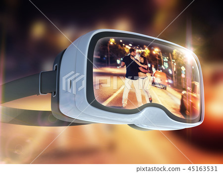 Virtual reality headset, double exposure. Young couple dancing tango on the quay Virtual reality headset, double exposure. Young couple dancing tango on the quay 45163531