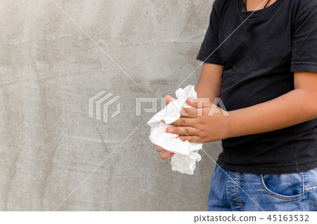 Asian boy cleaning his hands with wet tissue. 45163532