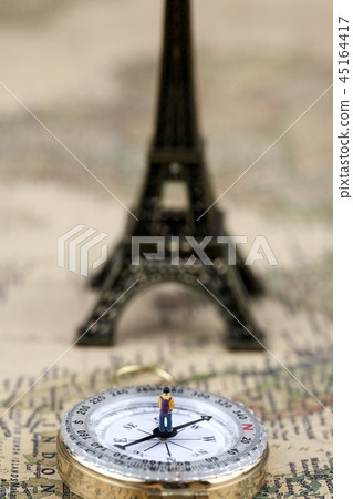 Miniature man with Eiffel Tower and compass 45164417