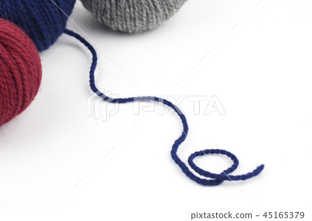 Red, blue and gray yarn on a white background 45165379