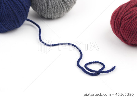 Red, blue and gray yarn on a white background 45165380
