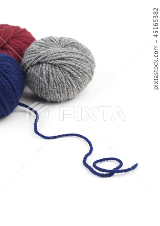 Red, blue and gray yarn on a white background 45165382