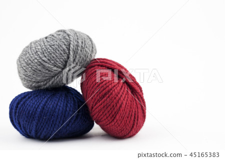 Red, blue and gray yarn on a white background 45165383