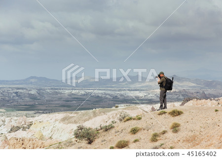 Photographer sandstone cliff and observing the natural landscape Photographer sandstone cliff and observing the natural landscape 45165402