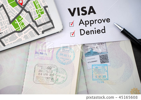 Visa and passport to approved stamped on a  45165608