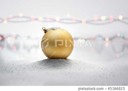 Yellow christmas ball on snow Yellow christmas ball on snow 45166825