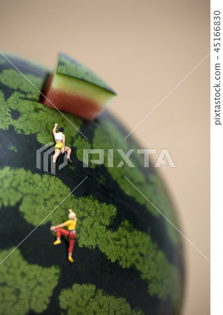 Miniature people climbing watermelons 45166830