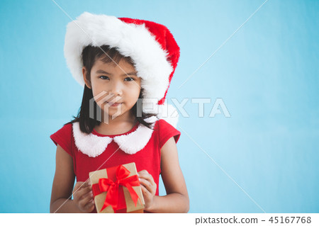 Cute asian child girl holding beautiful gift Cute asian child girl holding beautiful gift 45167768