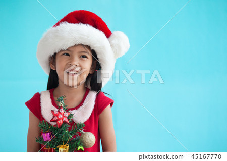 Cute asian child girl holding Christmas tree Cute asian child girl holding Christmas tree 45167770
