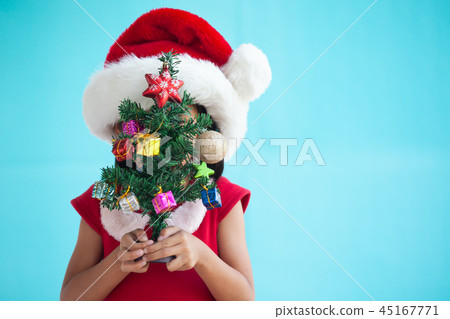 Cute asian child girl holding Christmas tree Cute asian child girl holding Christmas tree 45167771