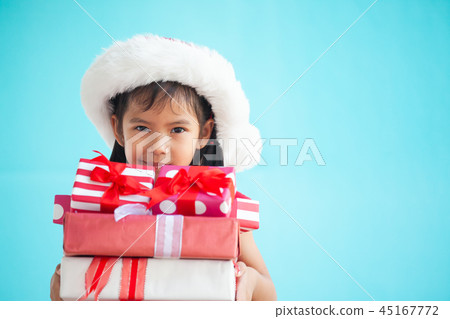 Cute asian child girl holding beautiful gift Cute asian child girl holding beautiful gift 45167772