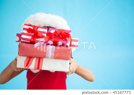 Cute asian child girl holding beautiful gift Cute asian child girl holding beautiful gift 45167773