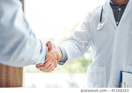 Confident Doctor shaking hands with patients talk 45168263