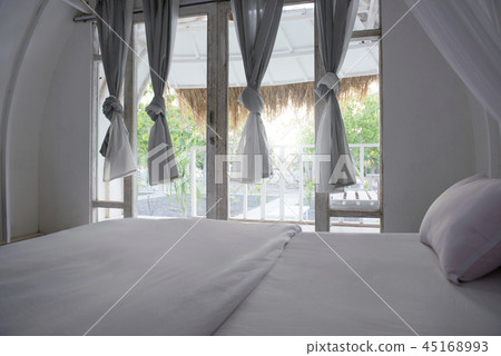 Interior of cottage with bed and curtain Interior of cottage with bed and curtain 45168993