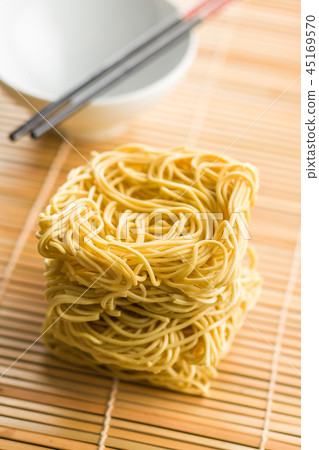 Uncooked instant chinese noodles. 45169570